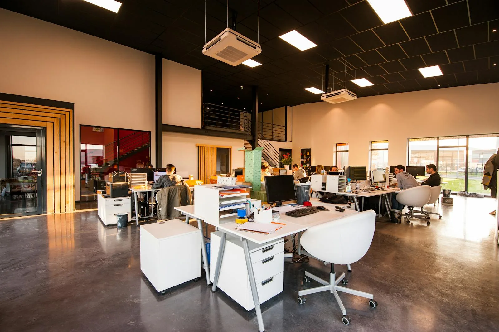 Open-plan office workspace with people