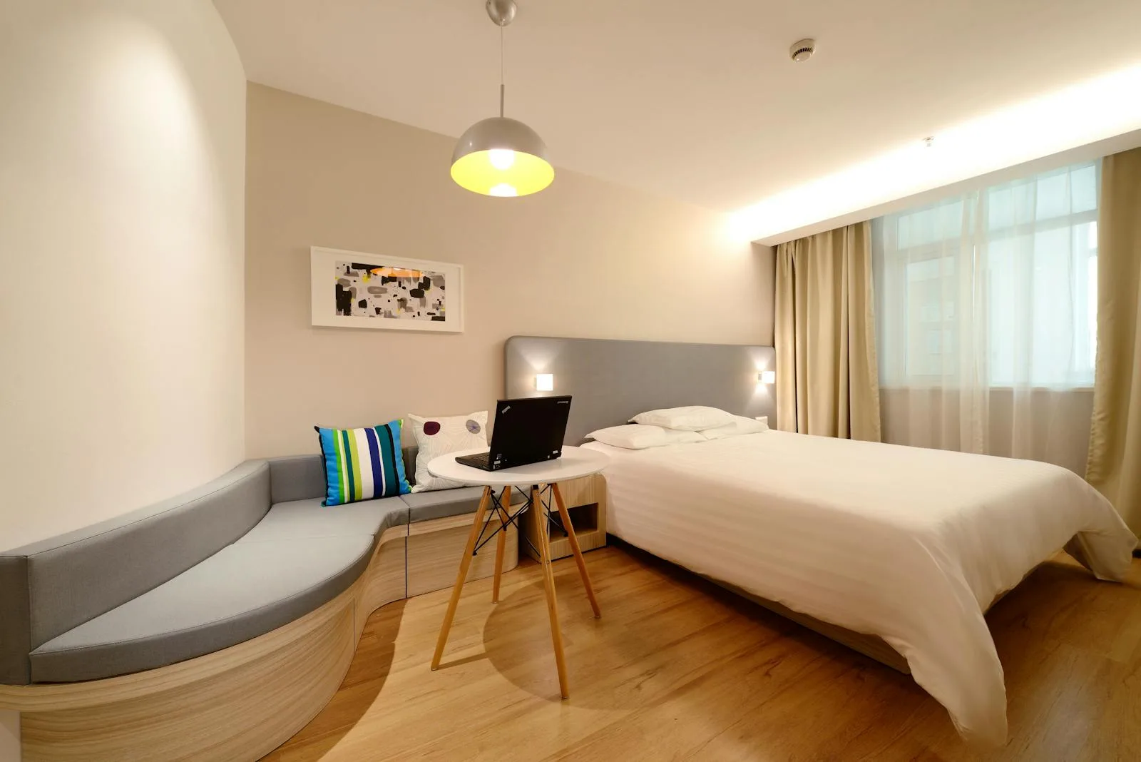 Hotel room with work desk and modern bed